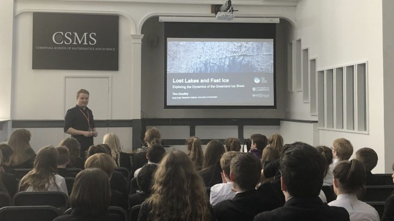 Giving a lecture to a school.